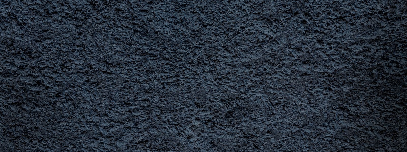 Textured dark blue surface pattern.