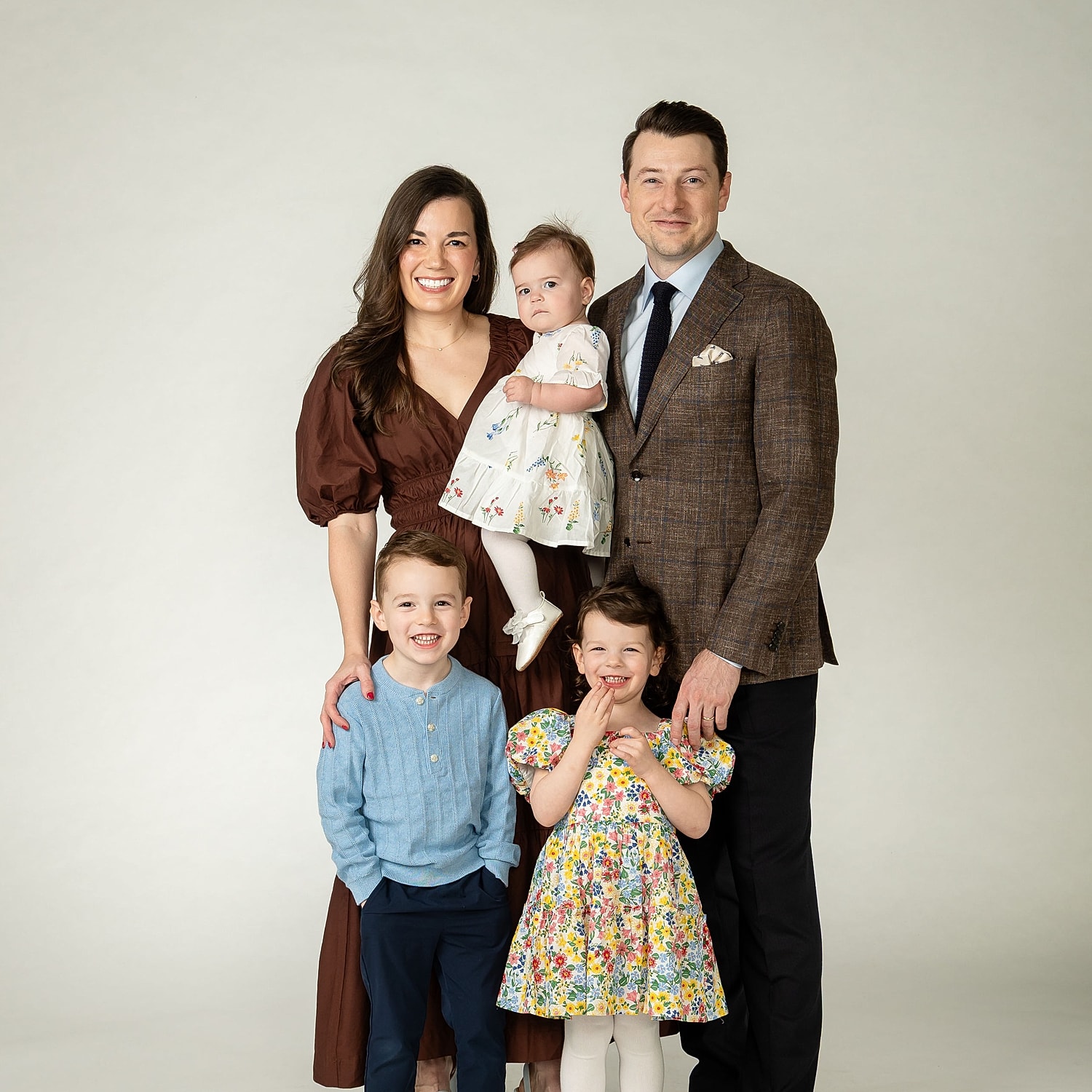 Family portrait with three children and parents.