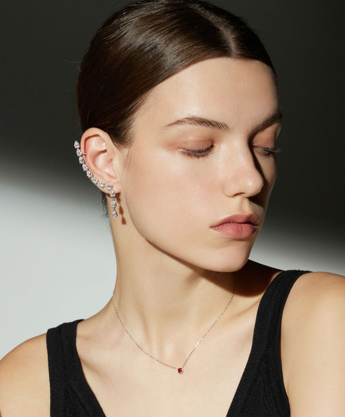 Model showcasing elegant earrings and necklace.