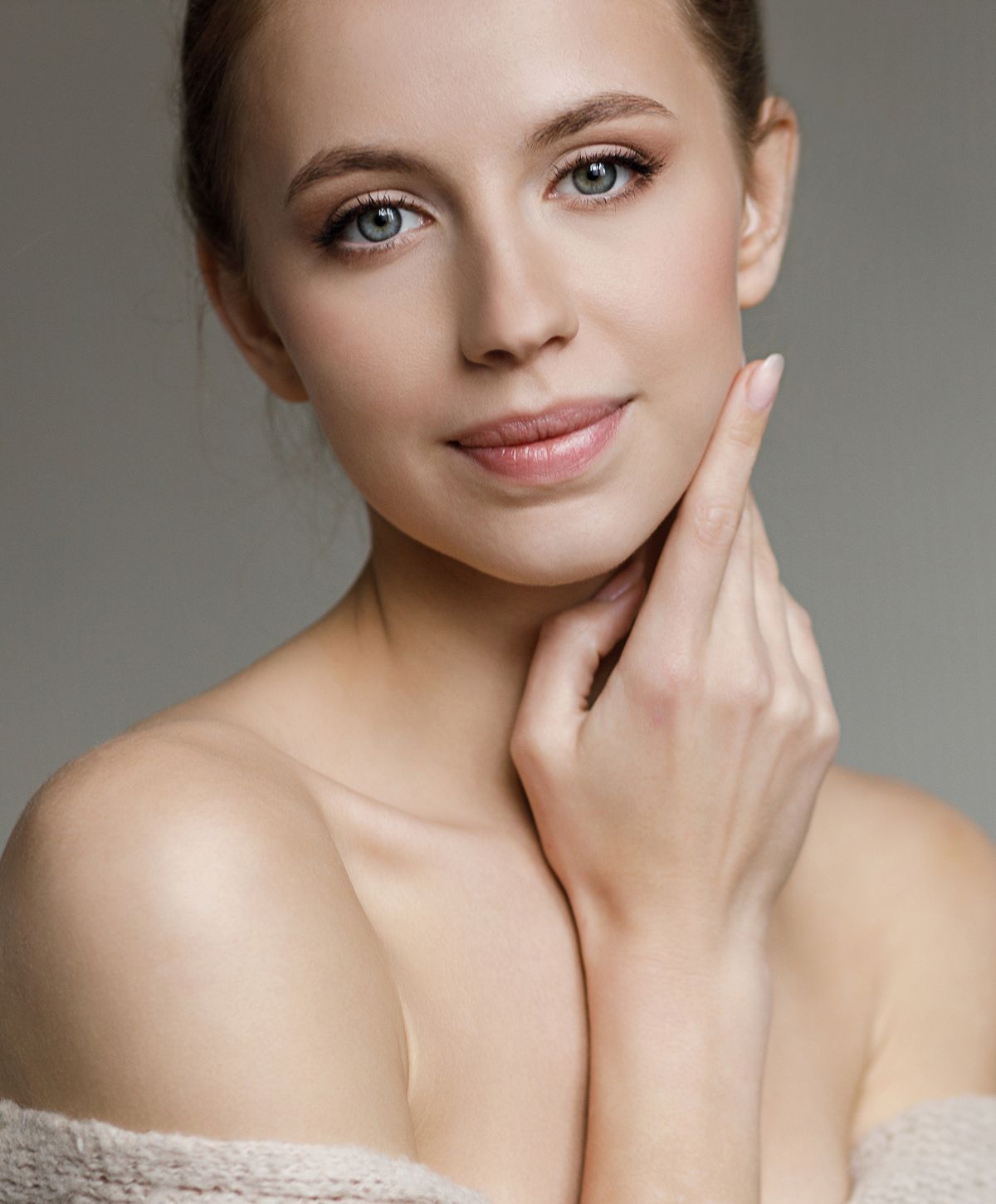 Close-up of woman with soft features and expression.