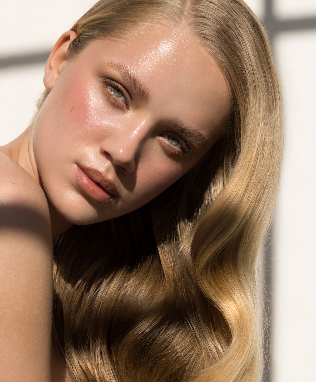 Portrait of a woman with flowing blonde hair.