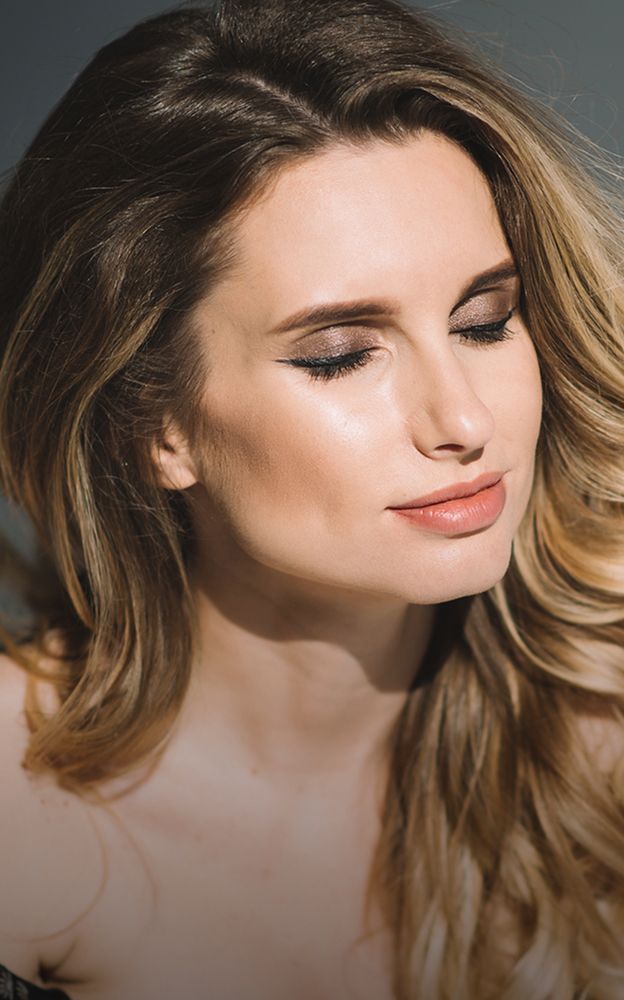 Woman with long hair and closed eyes.